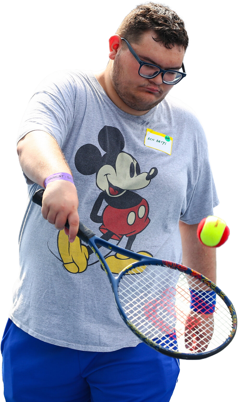 Male tennis player hitting a red tennis ball.