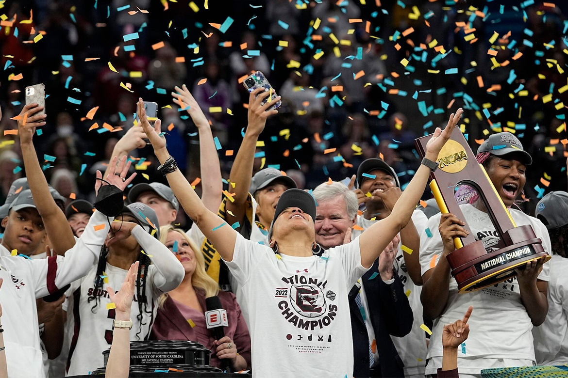 Dawn Staley celebrates with her team after winning the 2022 NCAA tournament