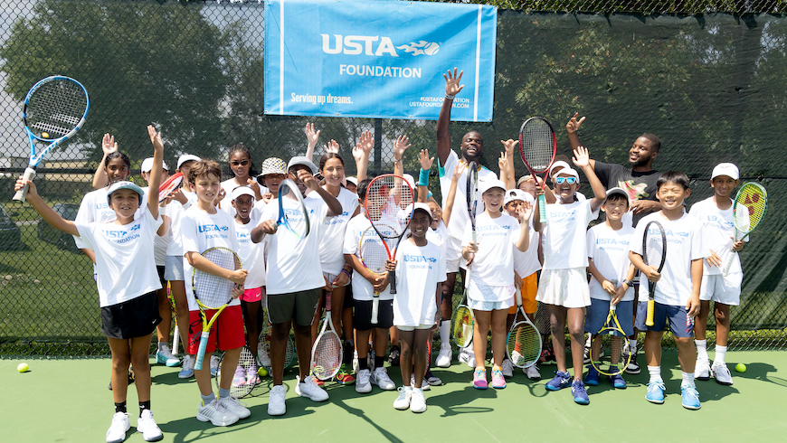 Frances Tiafoe smiling with kids.