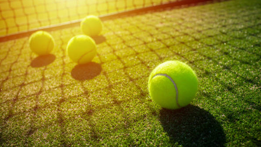 Tennis balls on grass court.